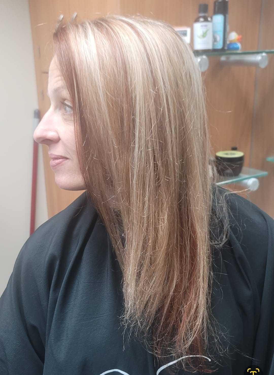 Hair salon: Woman with straight, highlighted hair sits for a styling session.