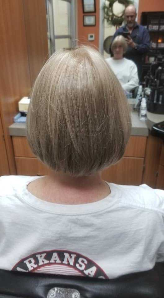 Short bob haircut viewed from behind in a salon setting.